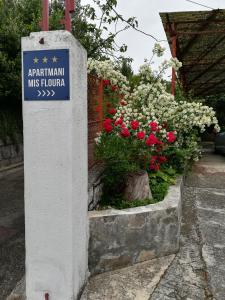 a sign for a museum with flowers in a garden at Apartment MIS Floura in Rijeka