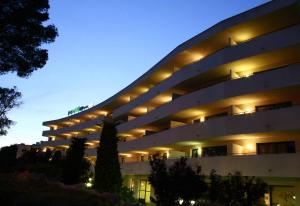 a building with lights on it at night at Festival Village Apartments in Salou