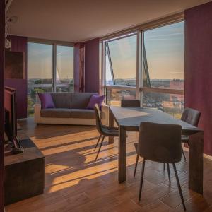 a living room with a table and chairs and a couch at Crystal Tower M&M in Treviolo