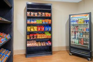 a refrigerator with food and drinks inside of a store at La Quinta by Wyndham Gonzales LA in Gonzales