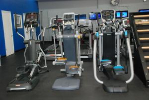 a gym with several tread machines in a room at Days Inn by Wyndham Dyersburg in Dyersburg