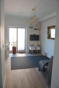 a living room with a couch and a table at Casa da Avenida in Póvoa de Varzim