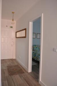 a hallway with a door leading to a bedroom at Casa da Avenida in Póvoa de Varzim