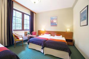 
Łóżko lub łóżka w pokoju w obiekcie Hotel Korona Park Klewinowo
