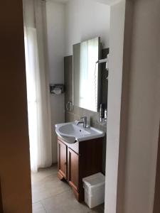 a bathroom with a sink and a mirror at Hotel Il Cavallino in Warendorf