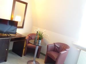 
a living room filled with furniture and a table at Value Stay Blankenberge in Blankenberge

