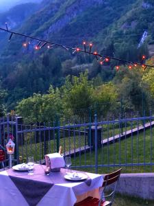 a table with a purple table cloth with a view of a mountain at Le Castagne Matte in Stenico