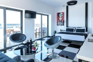 a bedroom with a king sized bed and a couch at Majestic Penthouse in the heart of Patra in Patra
