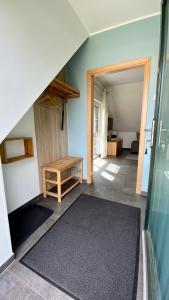 an attic room with a staircase and a room with a table at Spreewäldchen in Lübben