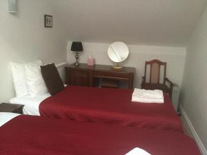 
a bedroom with a bed and a lamp at The Aldwick in Bognor Regis
