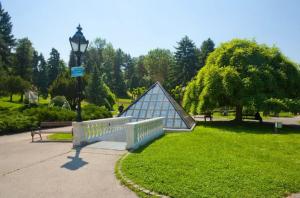 a park with a bench with a glass pyramid on it at Relax Apartment in Vrnjačka Banja