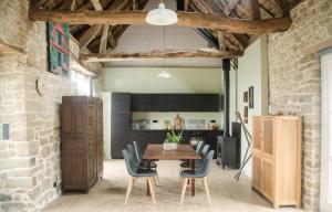 a dining room with a wooden table and chairs at Maison de charme Finistere 4 personnes in Quimper