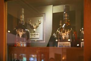 two bottles of alcohol sitting on top of a shelf at Chrielka Hotel in Limassol