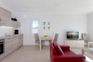 Μια τηλεόραση ή/και κέντρο ψυχαγωγίας στο Ferienwohnung Backbord