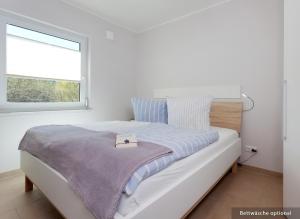 Ένα ή περισσότερα κρεβάτια σε δωμάτιο στο Ferienwohnung Backbord +19 φωτογραφίες