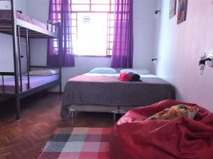 a bedroom with a bed and a desk at Rock! and Hostel in Belo Horizonte