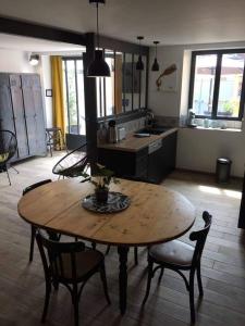 kuchnia z drewnianym stołem i krzesłami w pokoju w obiekcie le gite de Jules w mieście Azay-le-Rideau
