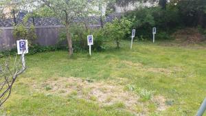 a group of signs in the grass in a yard at Haus Sandra in Ahlbeck