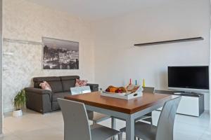a living room with a table and a couch at Modern and new apartment in Brianza in Vimercate