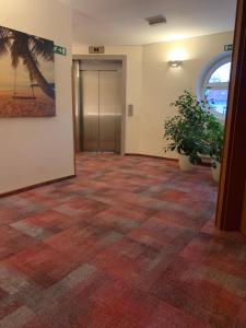 an office hallway with a tile floor and a door at Hotel Mantova in Vrhnika