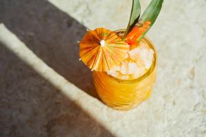a drink with an orange flower in a glass at Kimpton - Armory Hotel Bozeman by IHG in Bozeman +81 photos