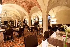 a restaurant with tables and chairs in a building at Schloss Raesfeld in Raesfeld