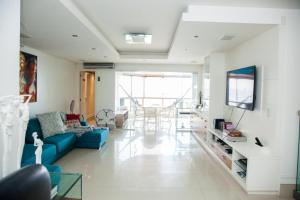 Μια τηλεόραση ή/και κέντρο ψυχαγωγίας στο Apto frente mar Bal Camboriu pé na areia churrasqueira carvao na sacada fantástica e encantadora vista mar