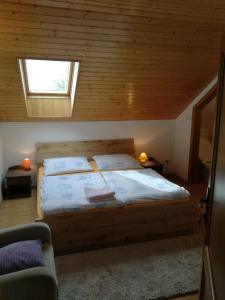 a bedroom with a large bed with a window at Vila Štefan Drevko in Poprad