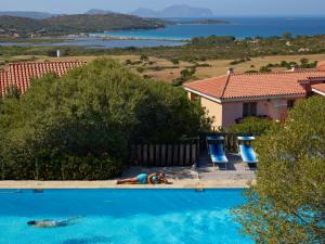 a woman laying on the side of a swimming pool at Residence Hotel Lu Nibareddu in San Teodoro