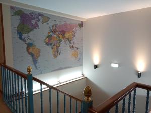 a map of the world on a wall next to a staircase at Pensión Begoña - centro ciudad in Bilbao