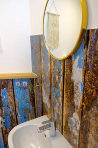 a bathroom with a mirror and a sink at Hacienda Rooms in Friedrichshafen +71 photos