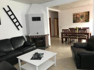a living room with a couch and a fireplace at Dat Sottje Huus in Wilhelmshaven