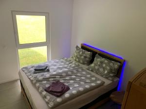 a bed in a room with a window at Haus Rading in Rading