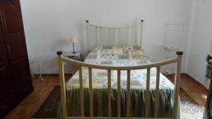 a small bedroom with a bed with a canopy at Casa de Férias in Monchique