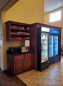 a grocery store with a refrigerator in a room at The Edgewood Hotel and Suites in Fairbury