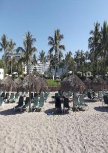 a group of chairs and umbrellas on a beach at Vidant At Nuevo Vallarta in Nuevo Vallarta 
