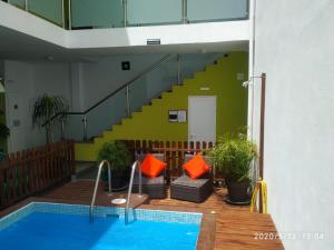 a swimming pool in a building with a staircase at Apartamentos El Patio in Los Llanos de Aridane