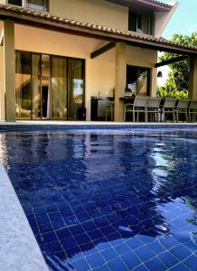 ein Pool vor einem Haus in der Unterkunft Bangalô Luxo Malawi Beach Houses in Porto De Galinhas