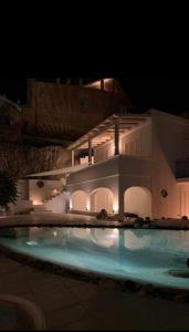 a building with a swimming pool at night at Casa Pesce in Ponza