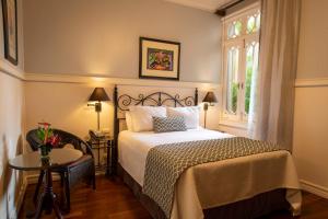 Rúm í herbergi á Grano de Oro Hotel