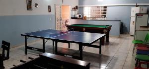 a ping pong table in a kitchen with a ping pong ball on at Chácara em Araçoiaba da Serra in Araçoiaba da Serra