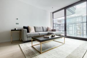 a living room with a couch and a coffee table at Sonder at Britain Quay in Dublin