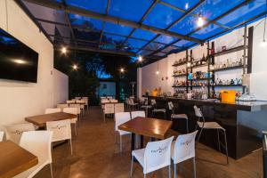 a restaurant with tables and chairs and a bar at Hotel Círculo Condesa in Mexico City