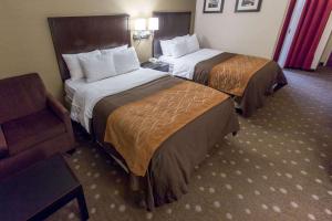 a hotel room with two beds and a chair at Comfort Inn Pittsburgh Crafton in Pittsburgh +27 photos
