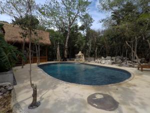 a swimming pool in a yard with a resort at Tulum Nueve in Tulum +40 photos