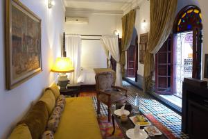 a living room with a couch and a table at La Maison Bleue Batha in Fez