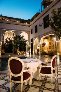a patio with a table and chairs in a building at Riad Maison Bleue and Spa in Fez