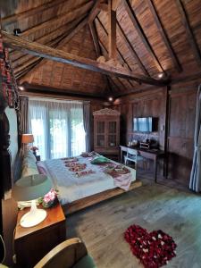 a large bedroom with a large bed and a desk at Rumah Batu Boutique Hotel in Solo