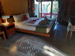 a bedroom with a bed with a heart drawn on the floor at Rumah Batu Boutique Hotel in Solo