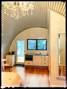 a large kitchen with a chandelier in a room at Romantic Couples Retreat in Mount Tamborine